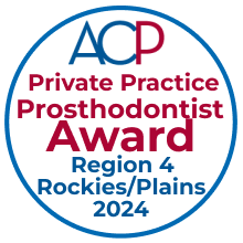 A photo of a prosthodontist accepting the ACP Private Practice Prosthodontist Award for Region 4 (Rockies/Plains) 2024: the recipient stands beaming on stage, holding the award in a polished setting with a backdrop showcasing the ACP logo and the event theme, highlighting excellence in prosthodontics.